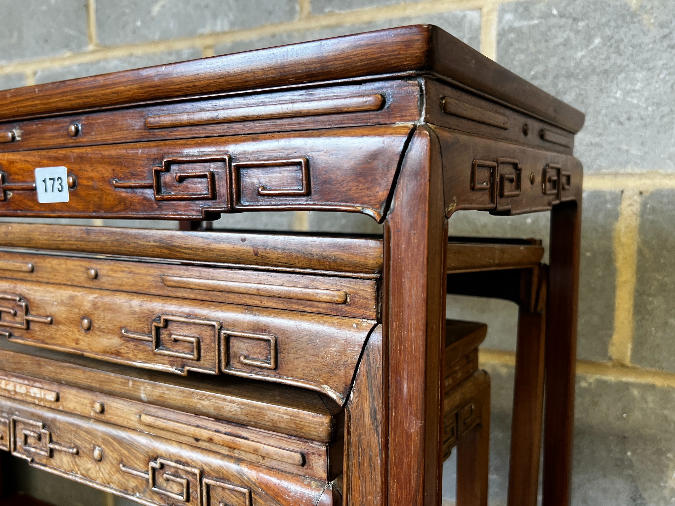 A nest of three Chinese rectangular hardwood tea tables, width 49cm, depth 35cm, height 59cm